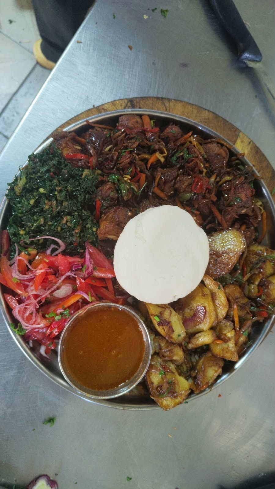 Nyama choma platter with ugali, greens and kachumbari