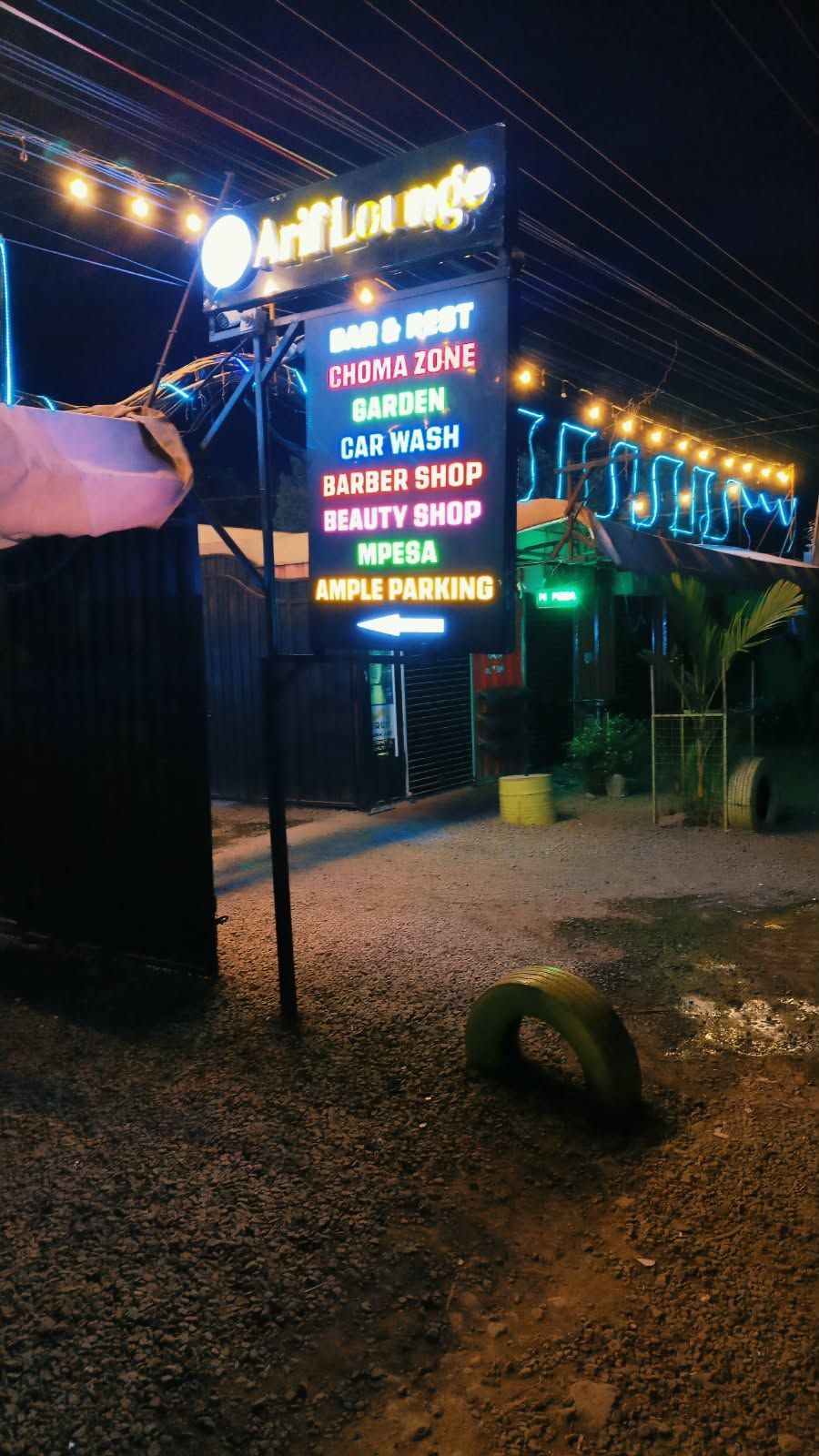 Arif Lounge signage listing bar, choma zone, car wash, barber shop and more