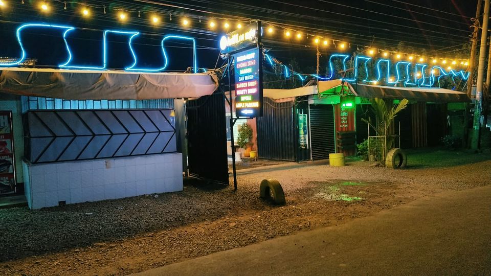 Arif Lounge frontage at night, neon lights and the signboard at the gate