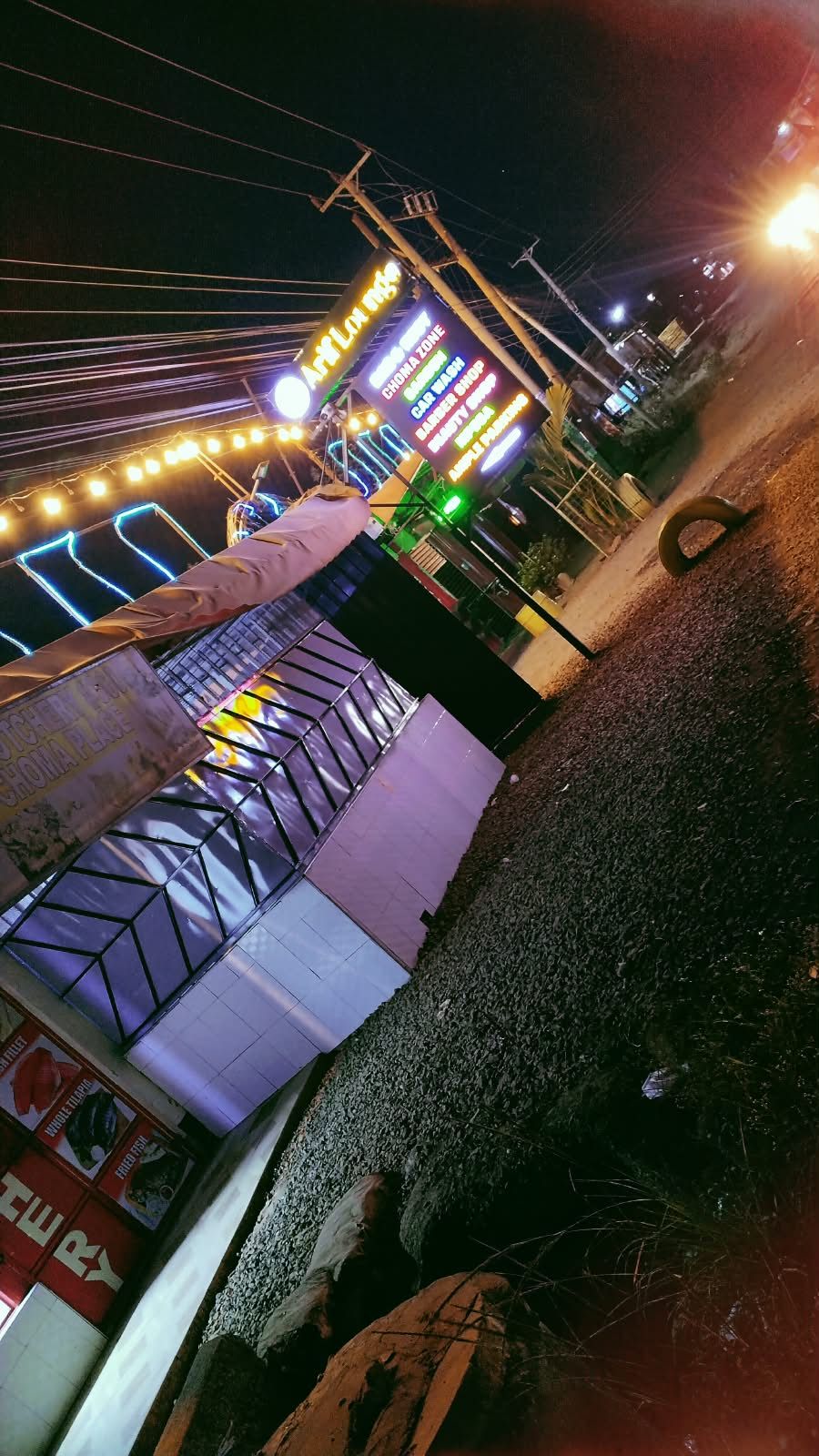 The lit signboard: choma zone, garden, car wash, barber shop, beauty shop, M-Pesa, ample parking
